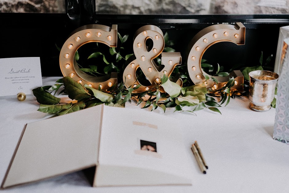 Marquee letters and greenery adorned the gift table where guests could also leave a candid photo in their guestbook.