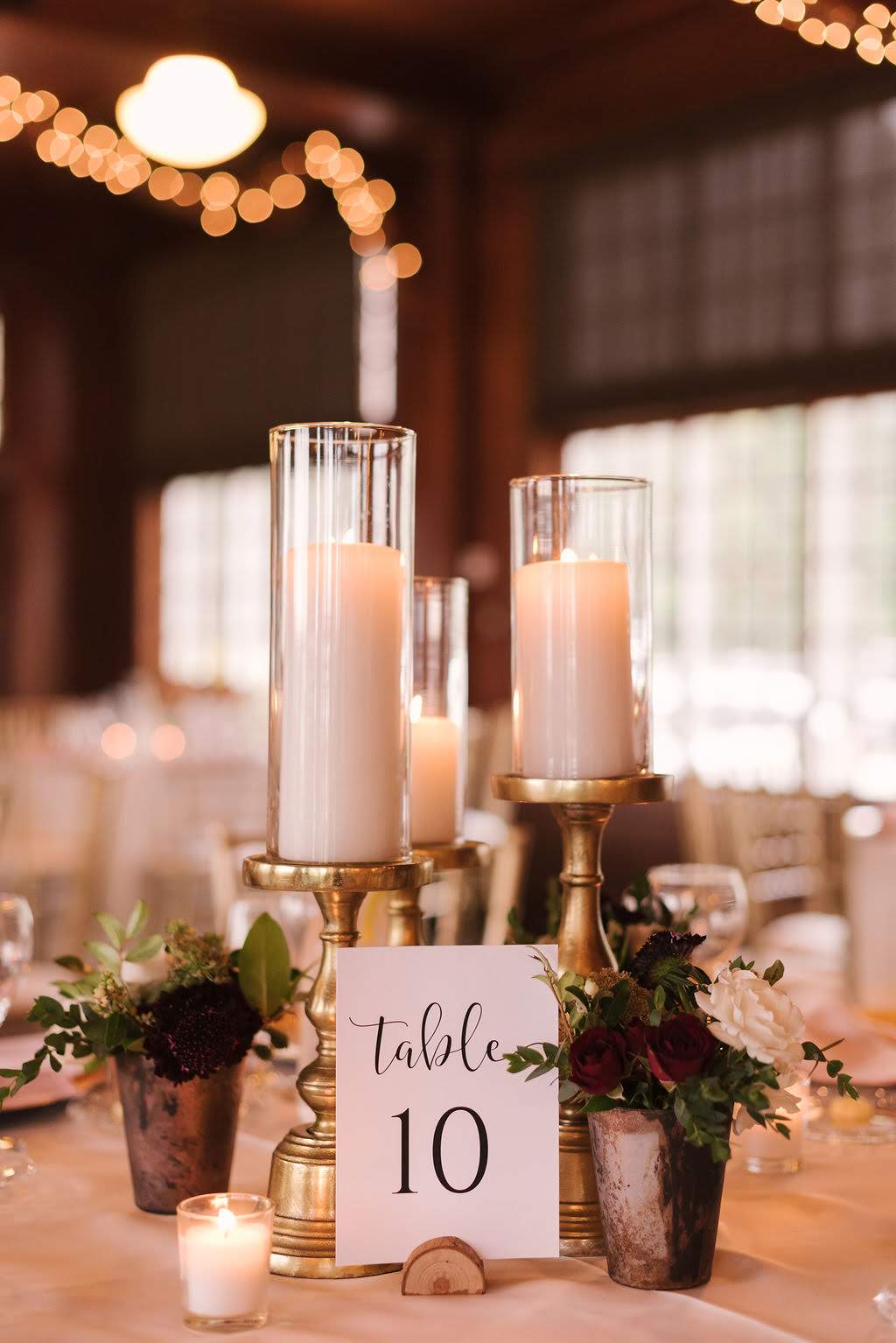 Pillar candles, votive candles and bud vases scattered around the room added a warm candlelit glow.