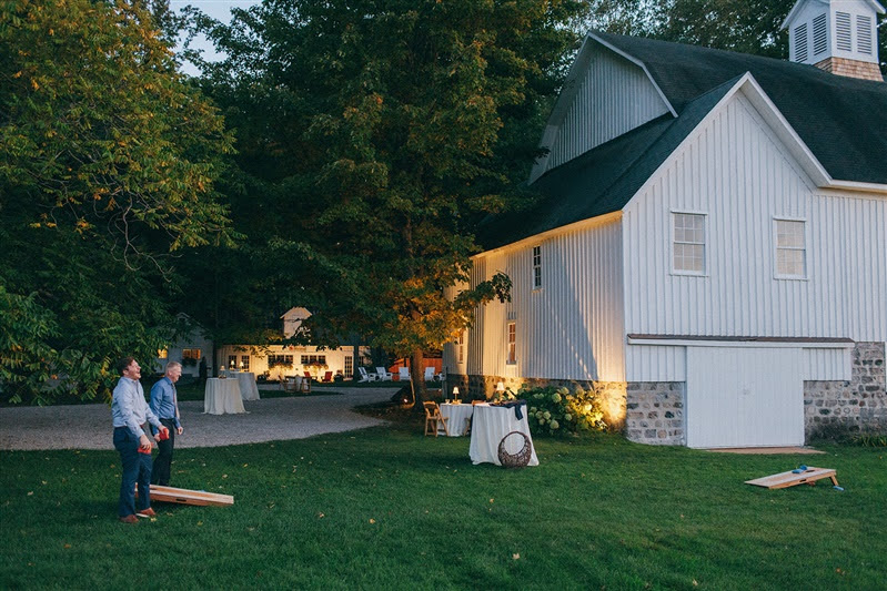 Guests playing cornhole during the evening outside of Cherry Basket Farm. 